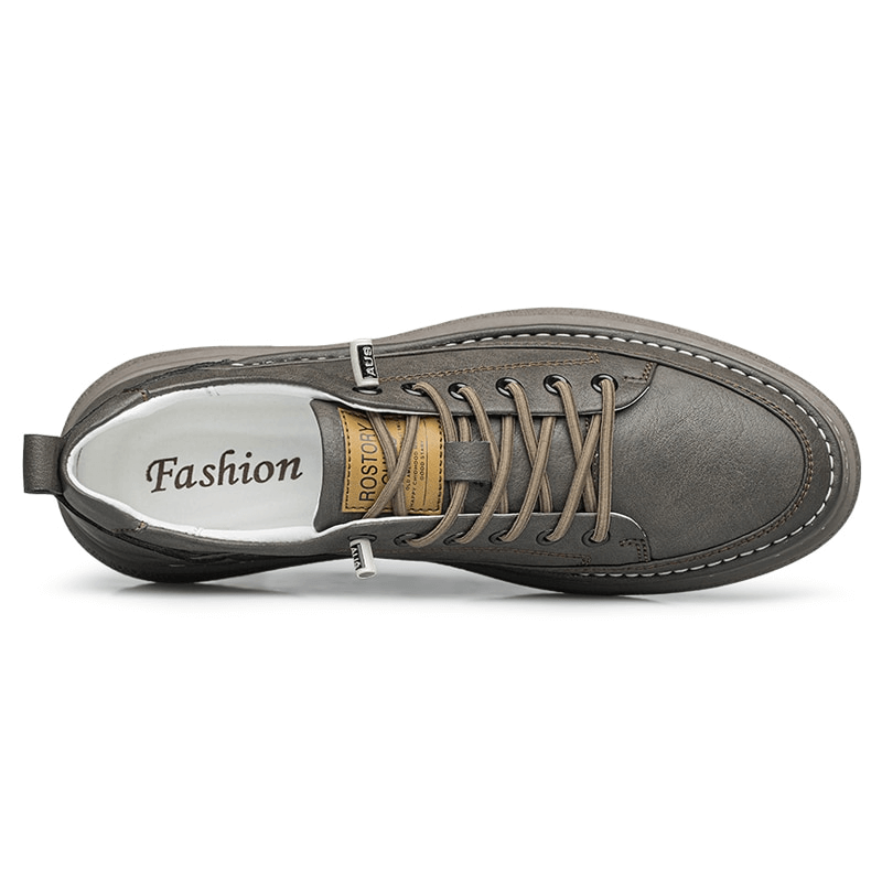 Top view of stylish leather breathable men's sneakers in gray with lace-up closure, perfect for athletes and casual wearers.
